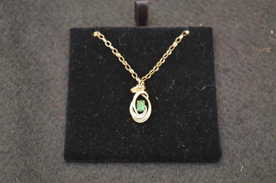 A 9ct Gold Emerald and Diamond Pendant on a 9ct Gold Chain