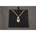 A 9ct Gold Emerald and Diamond Pendant on a 9ct Gold Chain