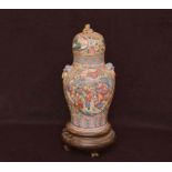 An Oriental Lidded Vase on Hardwood Stand