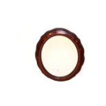 An Oval Mahogany Framed Wall Mirror