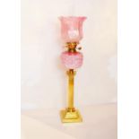 A Corinthian Pillar Based Oil Lamp, Embossed Pink Bowl and Ruby Shade