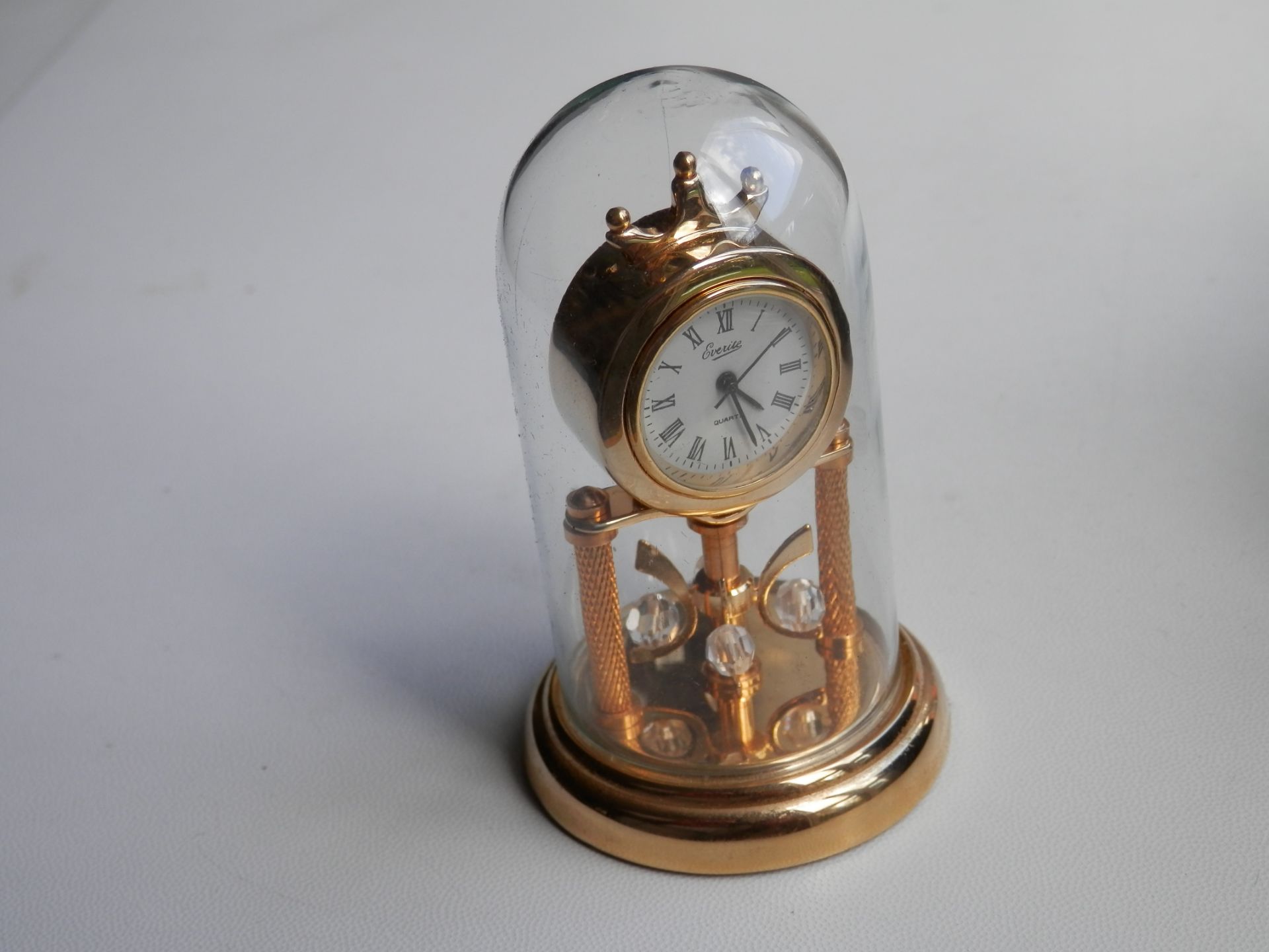 LOVELY 3" EVERITE WORKING BRASS ANNIVERSARY QUARTZ MINIATURE CLOCK WITH GLASS DOME & CASE.