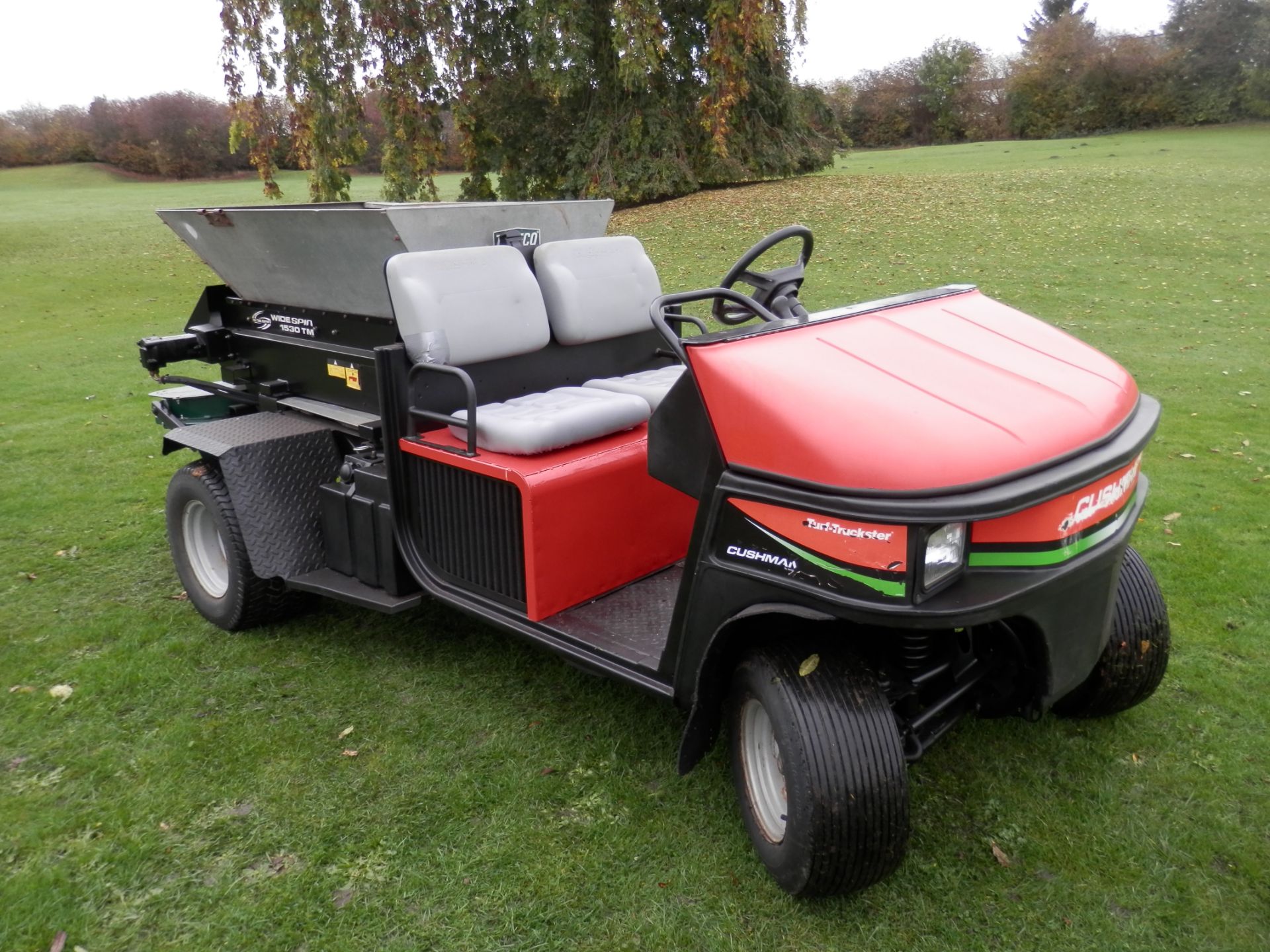 CUSHMAN TURF TRUCKSTER SPREADER WITH WIDESPIN 1530 REAR. GREAT WORKING UNIT.