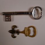 1 white metal key shaped corkscrew / bottle opener & 1 brass fleur-de-lys shaped bottle opener