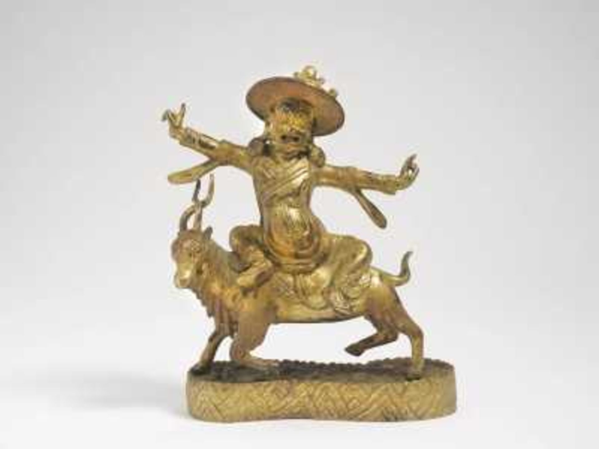 Dorje Legpa Tibet, 19. Jh. Bronze, vergoldet. Auf Terrainsockel auf einem Ziegenbock reitend. H.