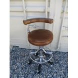 Wheeled dentist stool with swing arm.