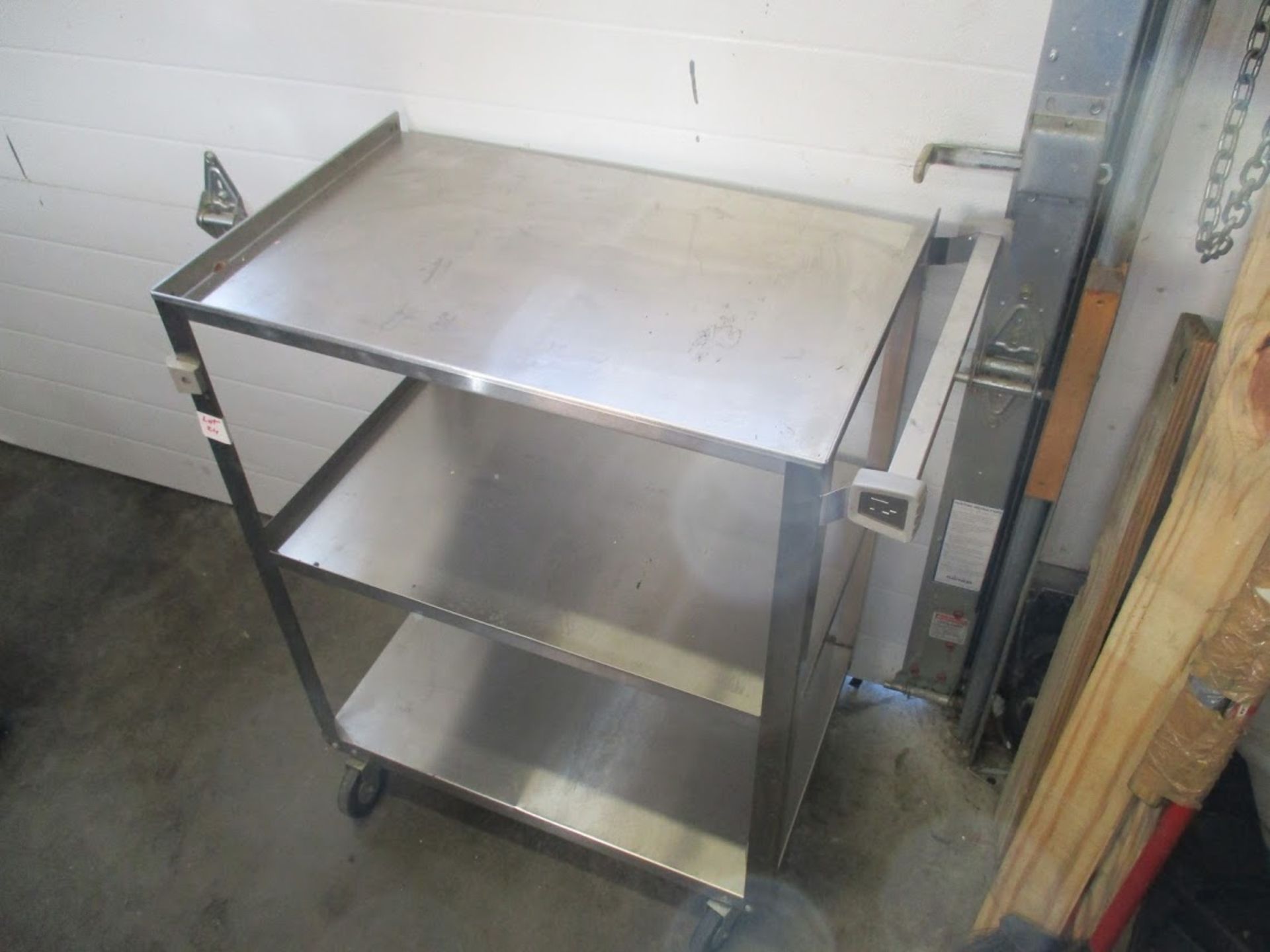 Stainless Steel wheeled medical cart with shelves.