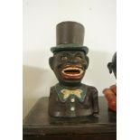 CAST IRON/ MONEY BOX - A vintage 'Jolly Nigger' novelty painted cast iron mechanical money box in