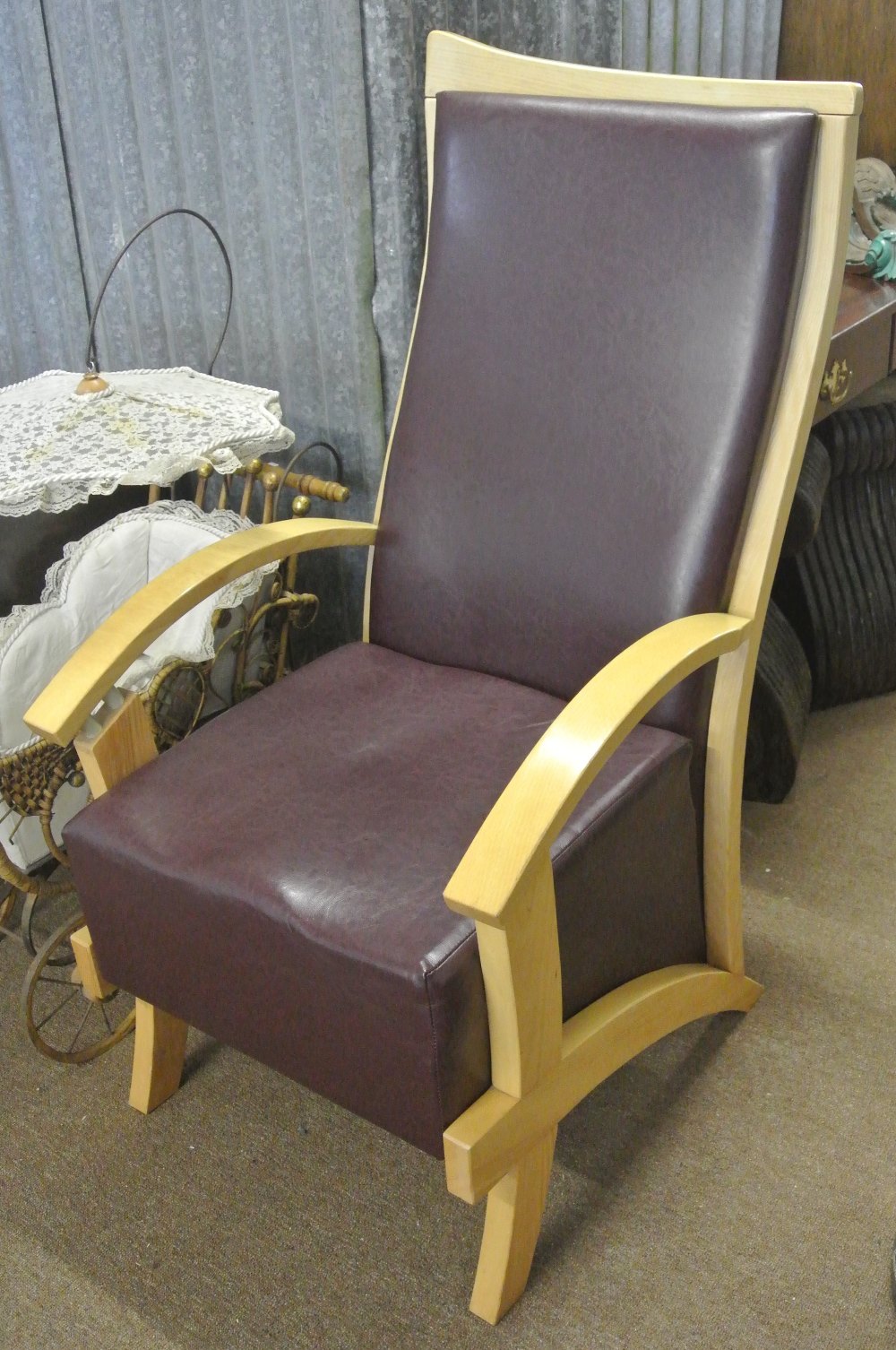 FURNITURE/ HOME - A large modern armchair with dark purple vinyl seat & back.