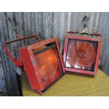 INDUSTRIAL/ LIGHTING - A pair of vintage metal theatre lights that have been painted orange.