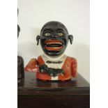 CAST IRON/ MONEY BOX - A vintage novelty painted cast iron mechanical money box in good condition,