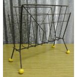 VINTAGE/ HOME - A fantastic Atomic style 1950's magazine rack, painted black with yellow ball feet.