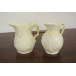 BELLEEK - A collection of 2 Belleek milk jugs, to include a shell design jug & a #0857 jug. Both