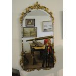 FURNITURE/ HOME - A vintage bevelled glass mirror in carved gold effect frame, measuring 38x82cm.