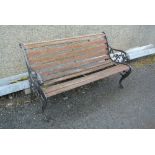 GARDEN/ FURNITURE - A garden bench with lion head cast iron ends. (Wood will require some