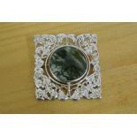 SILVER AGATE BROOCH: A hallmarked silver brooch in embossed design with swivelling central round