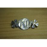 WHITE METAL RELIGIOUS SCENE BROOCH: A white metal bar brooch with Madonna scene and shamrock