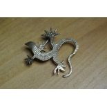 WHITE METAL LIZARD BROOCH: A gilded metal brooch in the form of a lizard. Engraved detail to the