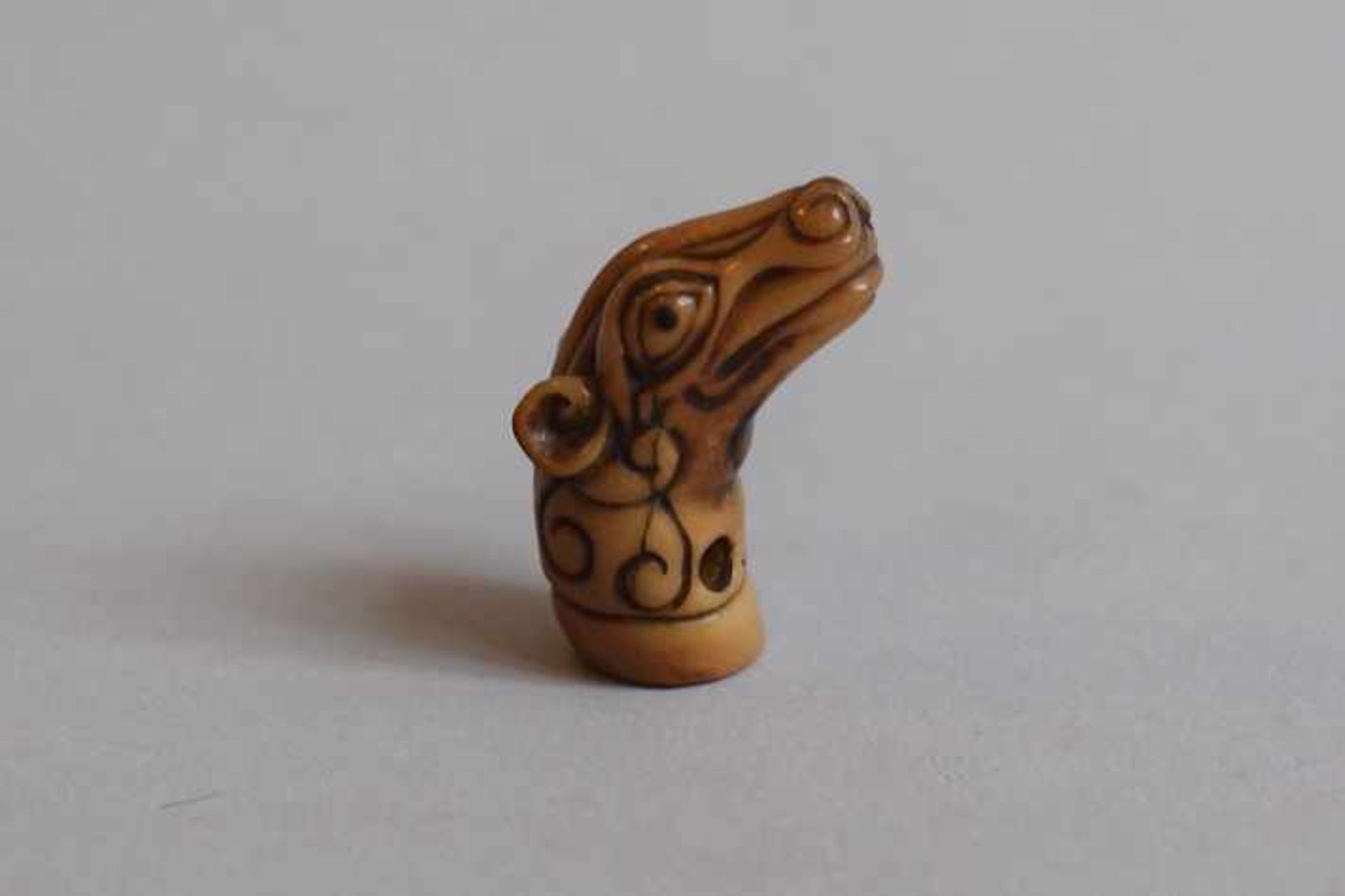 Palm Nut Seal Netsuke Anonymous artist Carved as the head of a mythical deer-like creature with