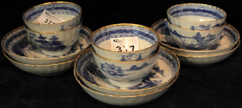 SET OF SIX CHINESE PORCELAIN UNDERGLAZED BLUE DECORATED TEA BOWLS AND SAUCERS with later gilded