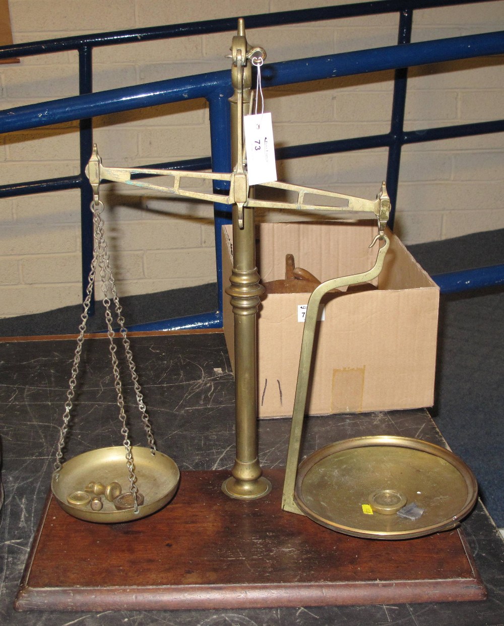 Set of brass pillar scales with brass pans, spall weights and on a mahogany base.