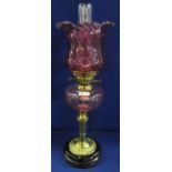 Early 20th Century brass double burner oil lamp with cranberry glass wrythen reservoir on brass
