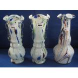 Garniture of three coloured glass baluster shaped vases, pair and one single.