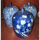 Pair of Oriental porcelain blue and white jars and covers together with another similar,