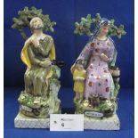 Pair of reproduction stoneware figure groups in the style of early Staffordshire,