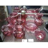 Group of assorted cranberry glass items to include: vases; bowls; sugar caster etc.