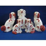 Two pairs of 20th Century Staffordshire pottery red and white over gilded seated Spaniels together