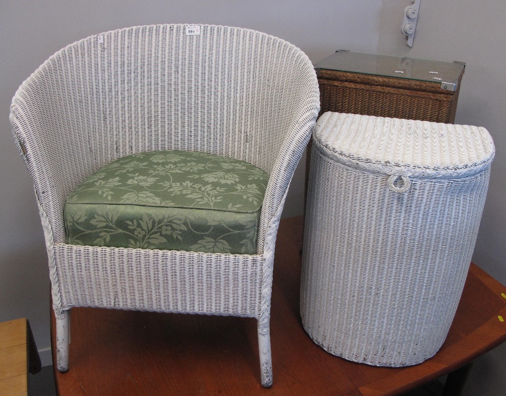 Three Lloyd Loom style wicker items to include two linen baskets and a tub type chair.