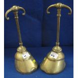 Pair of Victorian brass horses hoof shaped door stops with scrolled 'T' shaped handles.