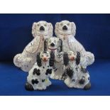 Pair of 19th Century Staffordshire Pottery black and white seated Spaniels with painted features