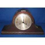 Mid 20th Century oak two train, hat shaped mantel clock with silvered Arabic face.