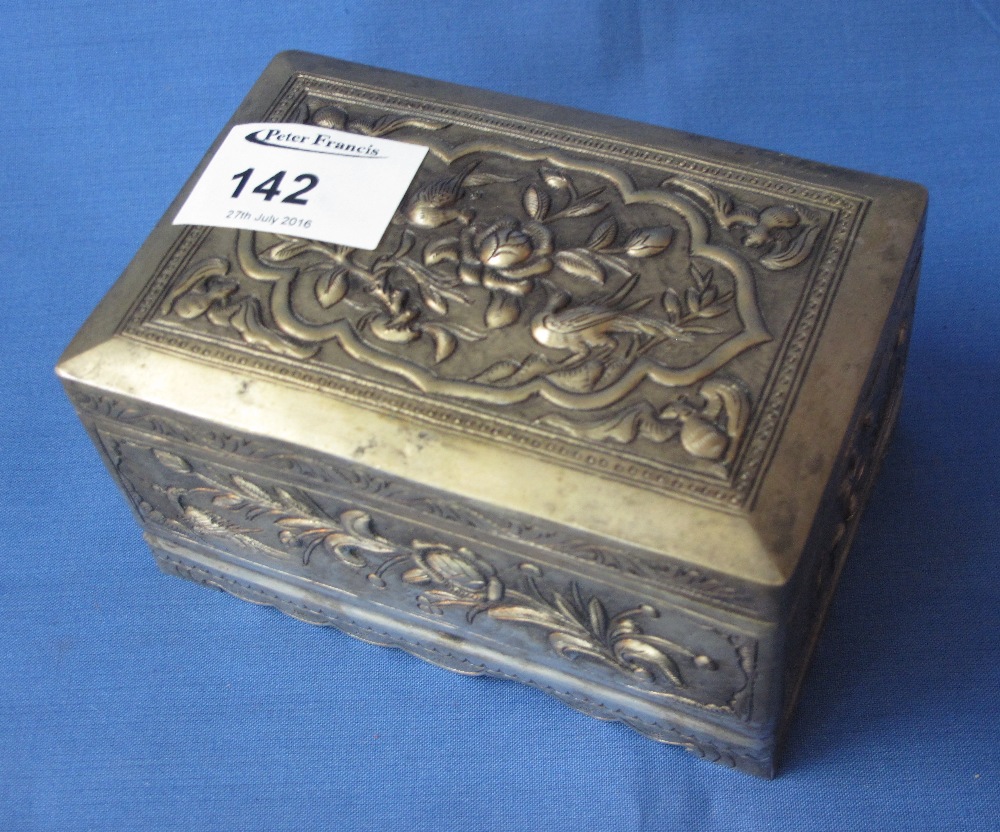 White metal rectangular lidded box probably Chinese with repousse decorated bats, birds and foliage.