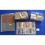 Small box of cigarette cards in tin and plastic box and few stamps in envelope.