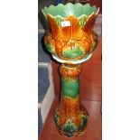 Majolica pottery foliate moulded baluster shaped jardiniere with matching stand.