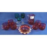 A group of assorted cranberry and other coloured glass items to include: wine glasses; cups;