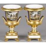 Pair of Paris porcelain urns, 19th c., decorated with hand painted landscapes with figures, 9 3/