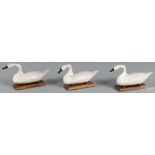 Three miniature carved and painted swans, 20th c., 4'' h., 8'' w.