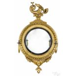 Giltwood convex mirror, ca. 1800, with a sea serpent crest and two girandole arms, 48 1/2'' h.