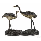 Japanese bronze cranes mounted on a carved wooden bases, 16 1/2'' h., 19 1/2'' w.