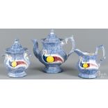 Reproduction blue spatter teapot, sugar, and creamer.