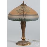 Reverse painted table lamp, early 20th c., with a gilt cast iron base, 22 1/2'' h., 16'' dia.