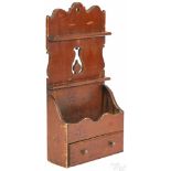 Painted pine hanging spoon rack, ca. 1830, retaining an old red surface, 27 1/2'' h., 13 1/2'' w.