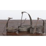 Two wrought iron Betty lamps, ca. 1800, one with a bird finial, 4'' h., and one stamped H & R Boker,