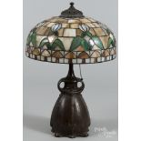 Art Nouveau patinated white metal table lamp, early 20th c., with a leaded glass shade, 23'' h.,