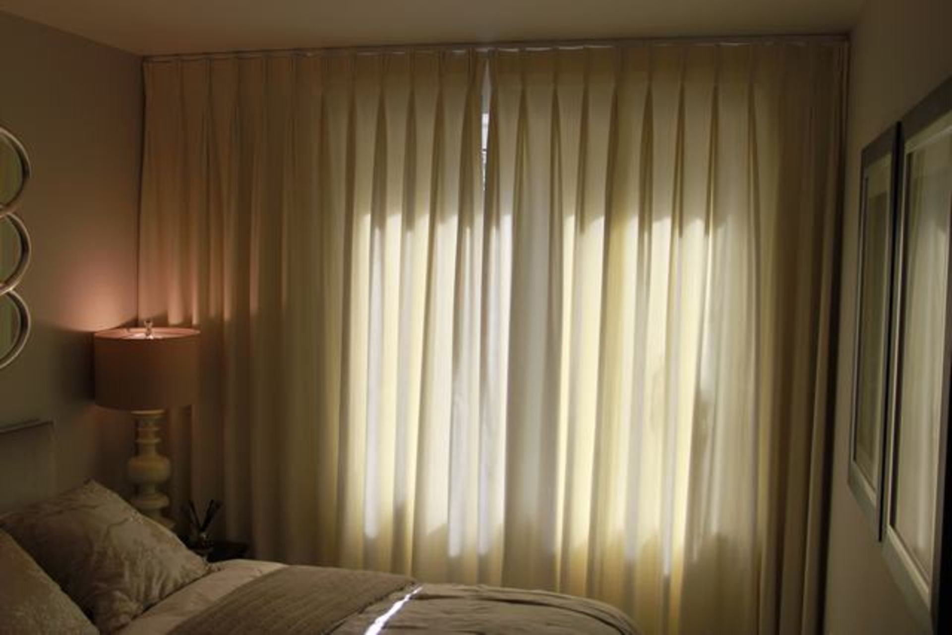 A pair of cream fully lined curtains 2600mm x 2400mm