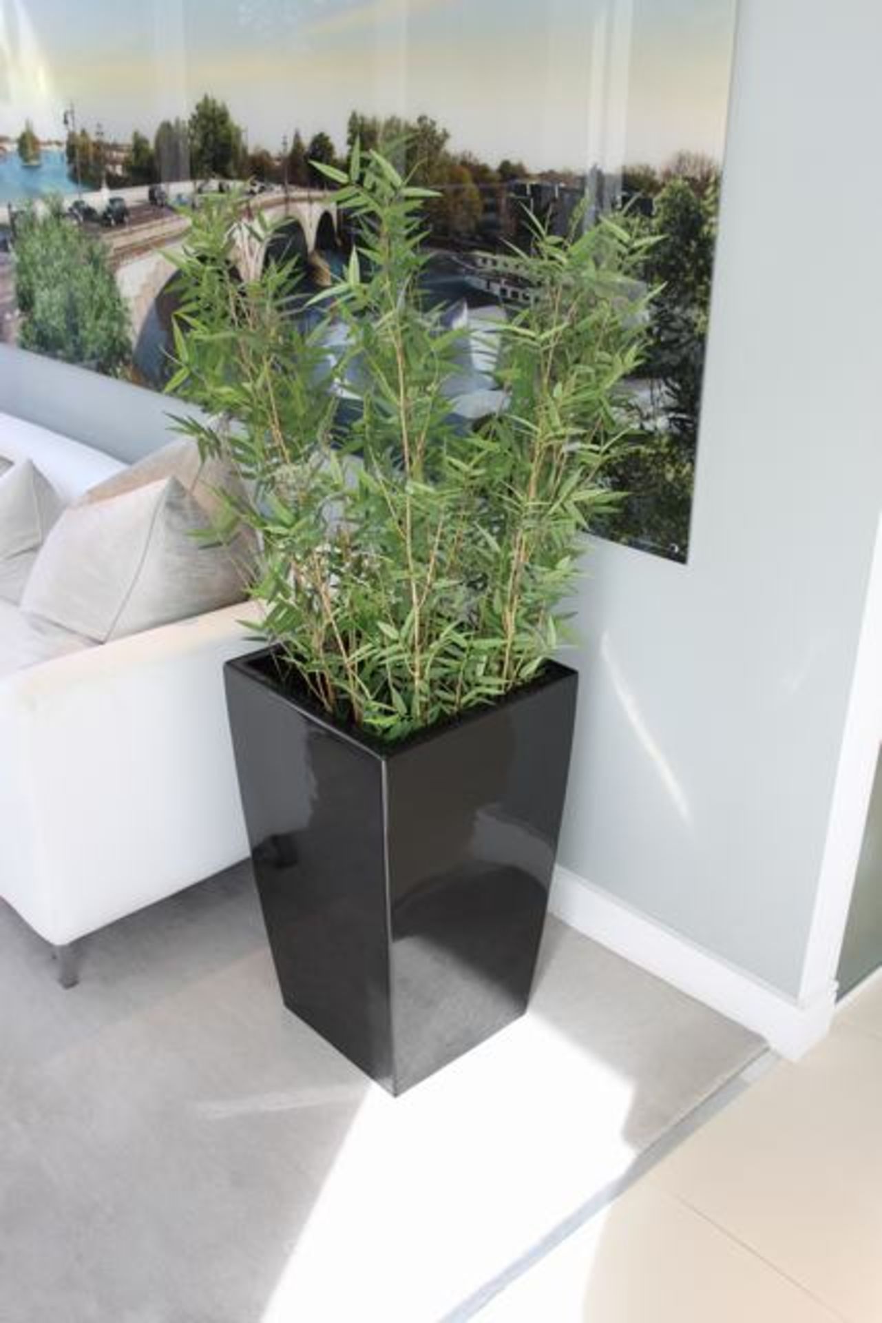 A pair of black cubico planters tapered planter that is lightweight, durable, UV and frost resistant